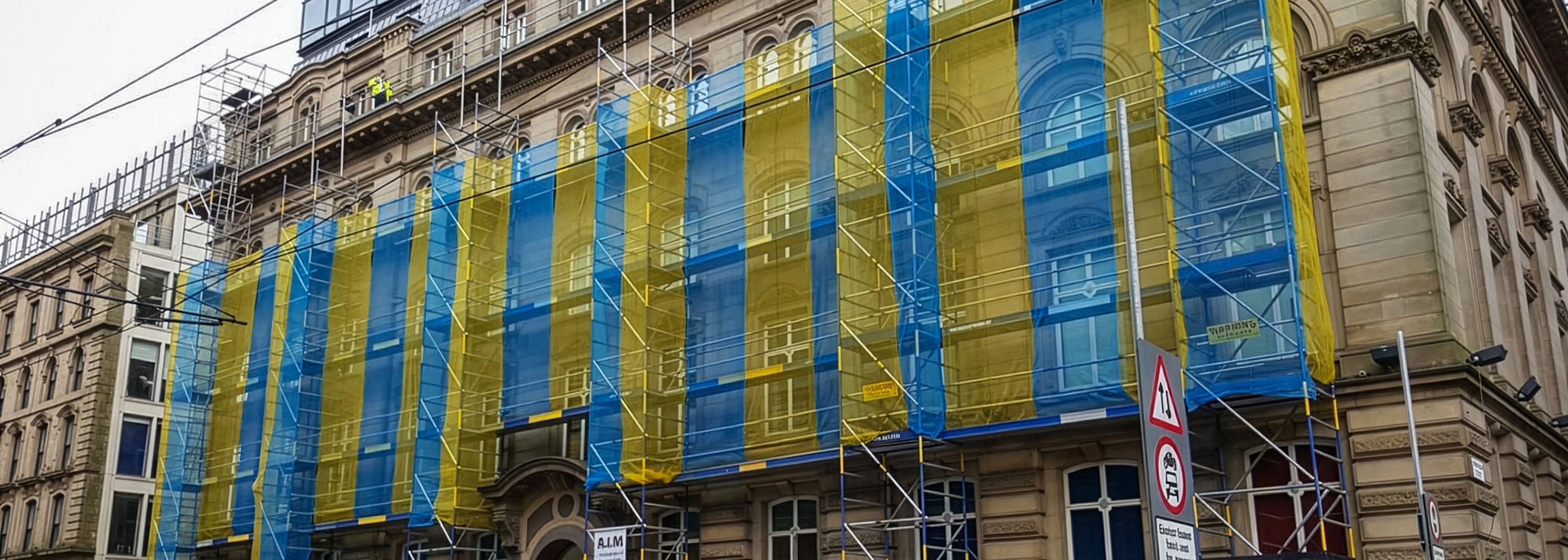 A Linked run of Alto HD towers against a city centre building.