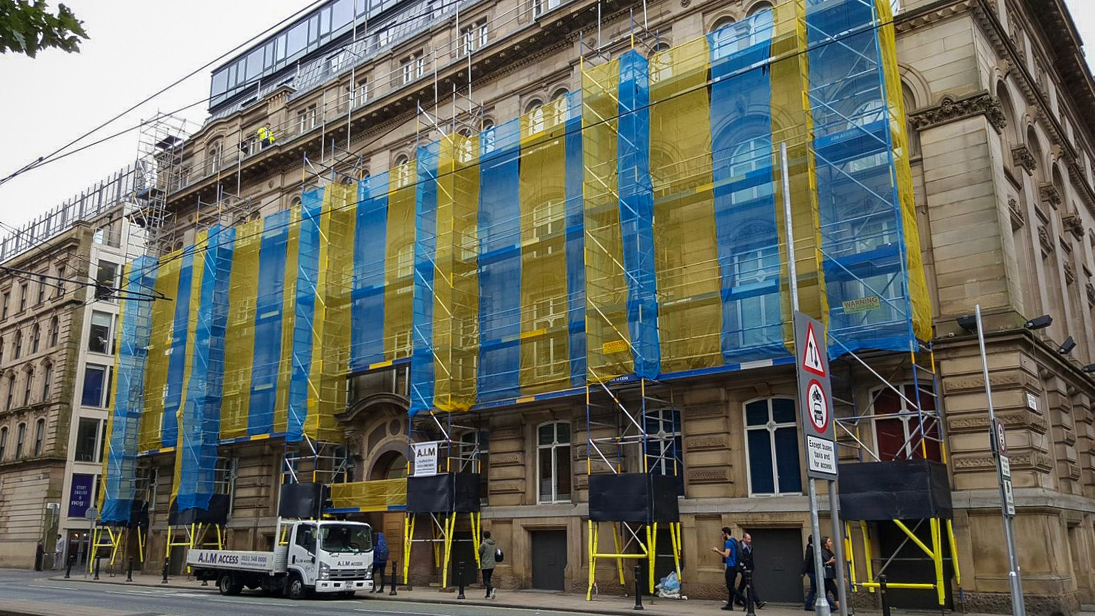 A Linked run of Alto HD towers against a city centre building.