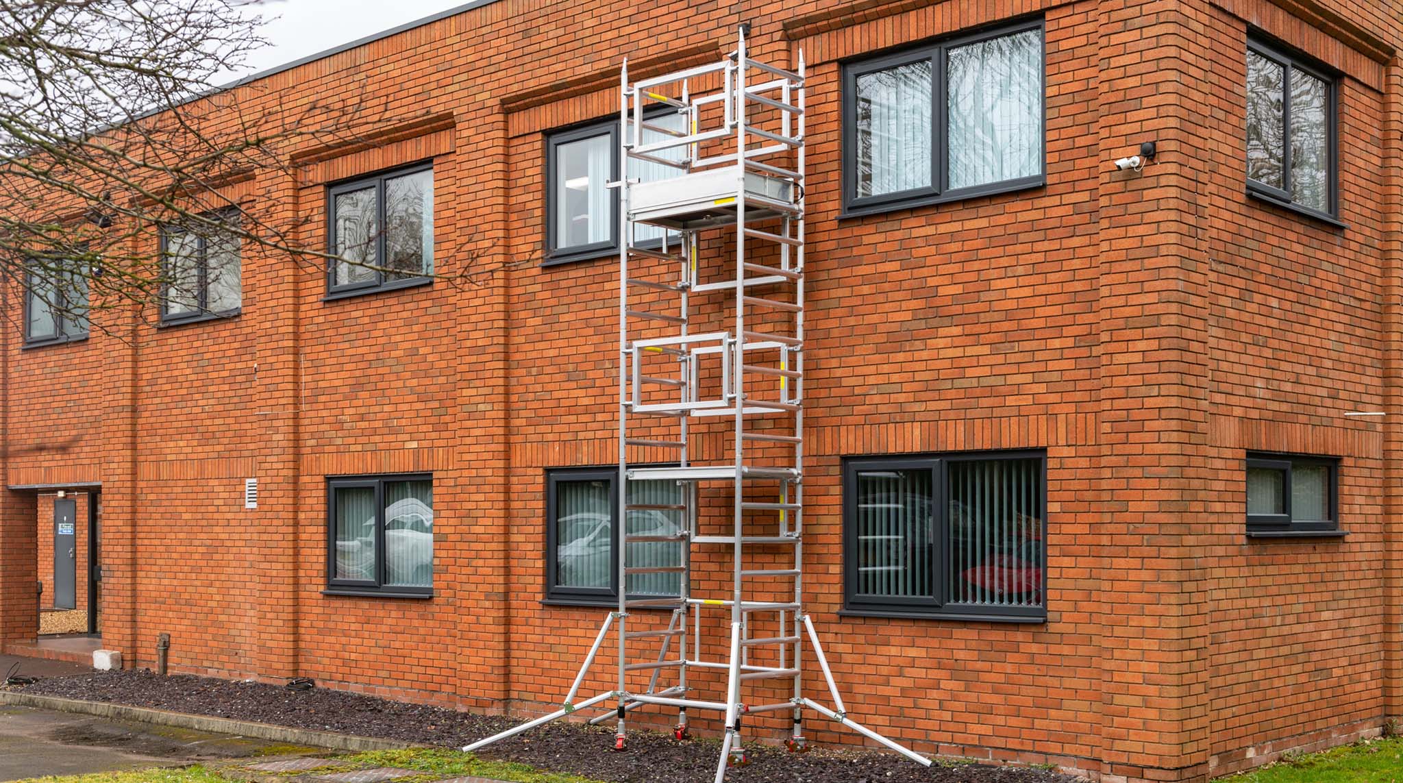 A photo of the Alto Mini Tower against an office building