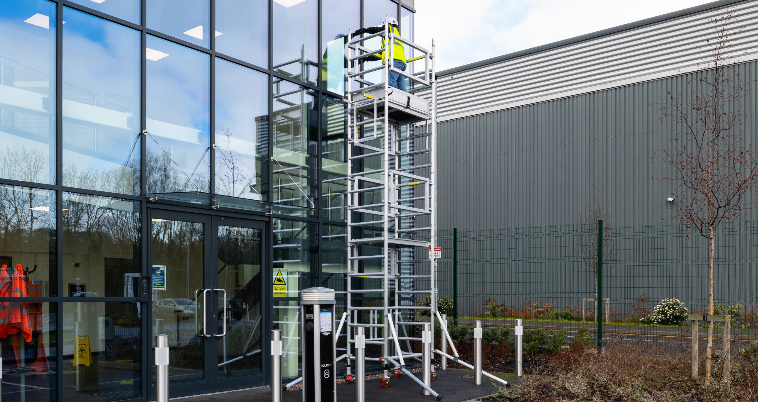 A photo of the Alto Mini Tower against a glass fronted building