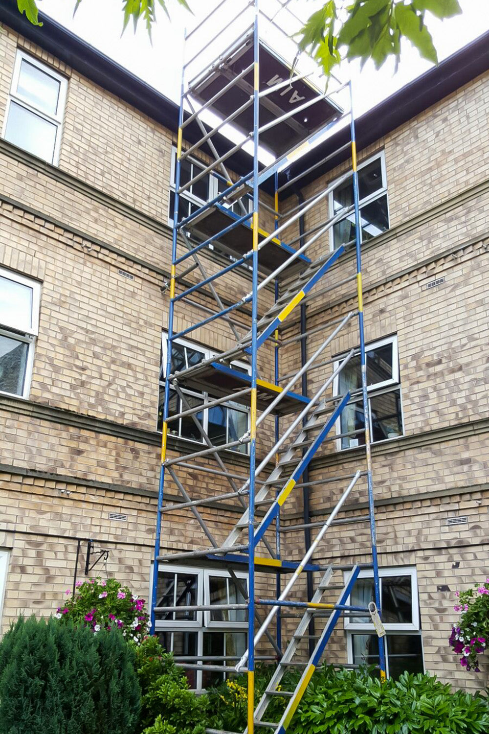 An Alto HD Stair Tower built against an apartment block.