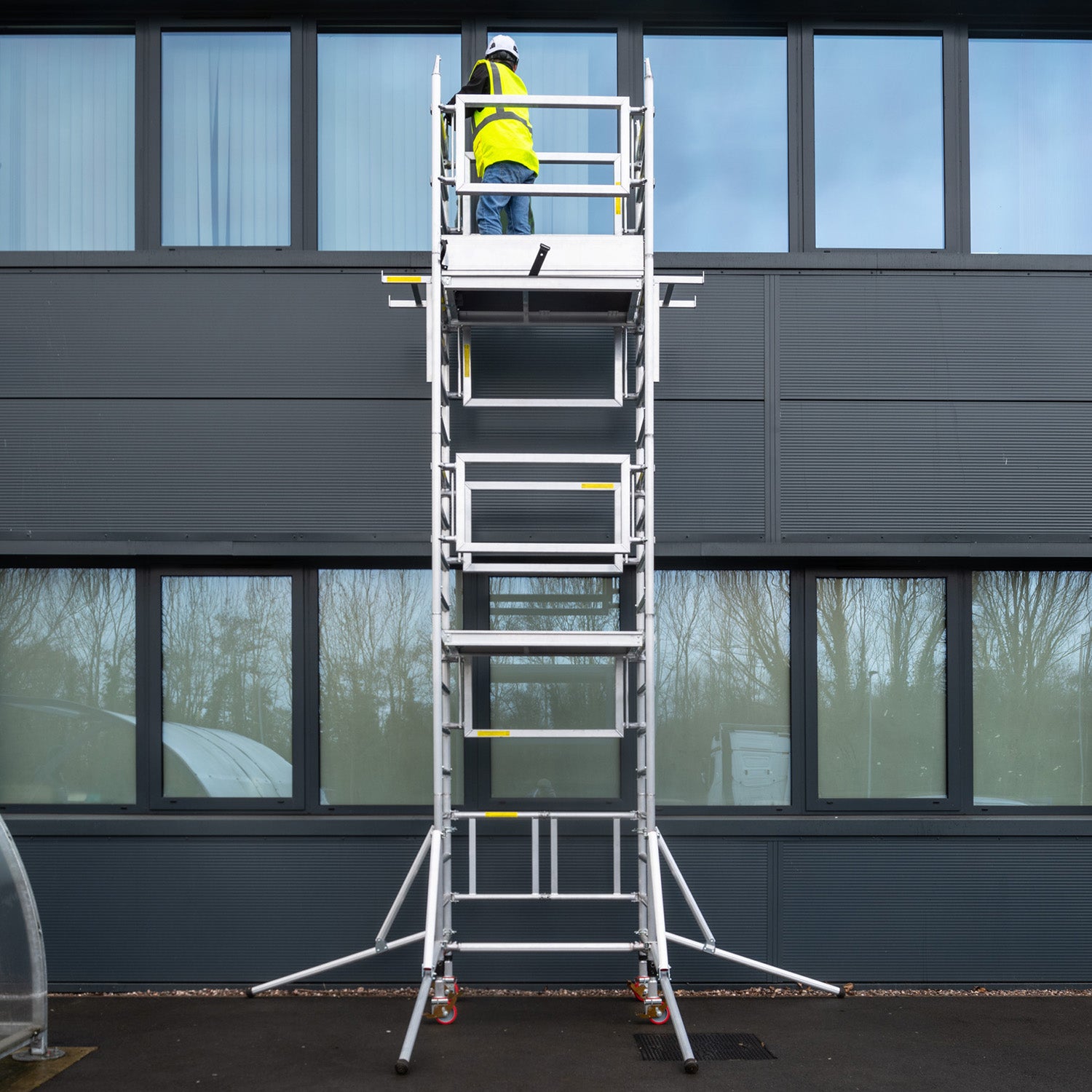 A photo of the Alto Mini Tower against a modern office building.