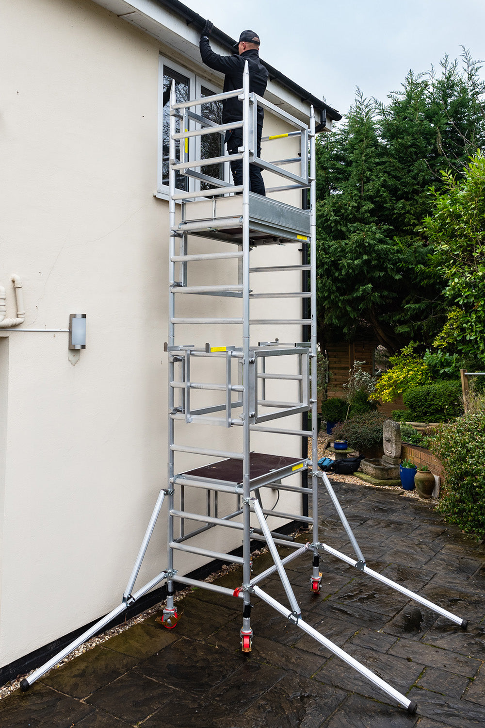 A photo of the Alto Mini Tower being used against a house.