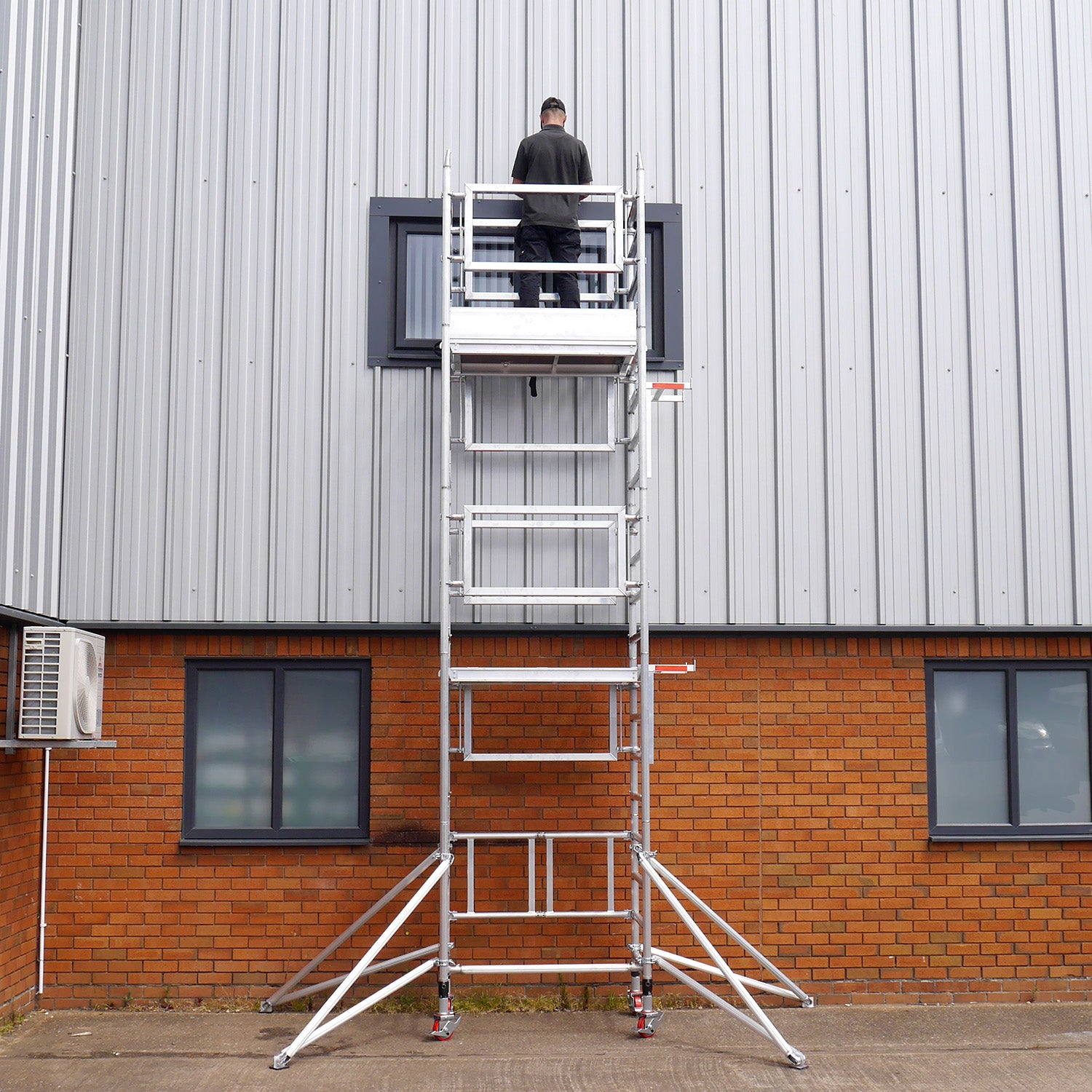 A photo of the Alto Mini Tower against a factory building.