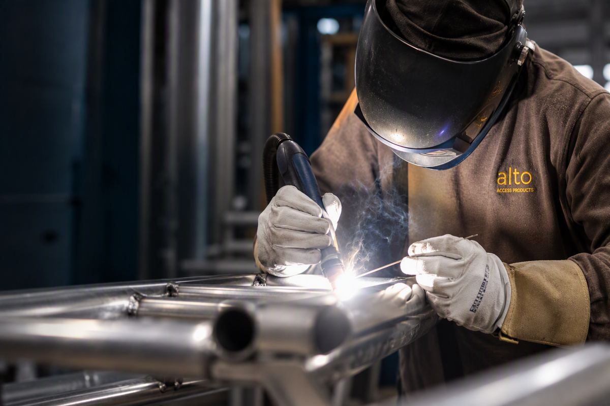 Alto Access employee welding aluminium access equipment at the company's UK manufacturing facility.