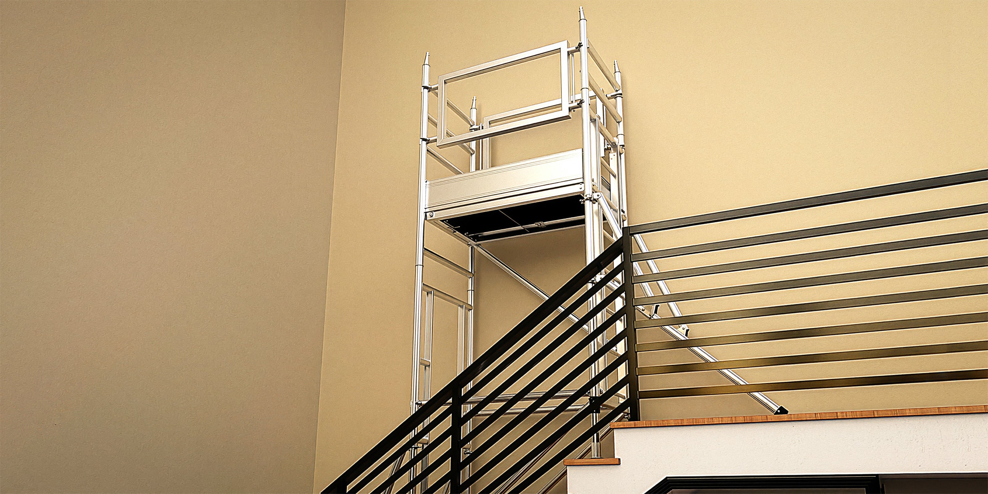 A photo of a Stairwell-Pro Tower on a staircase with black metal handrails.